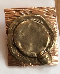 Metal clay design of a traditional Inuit drum.